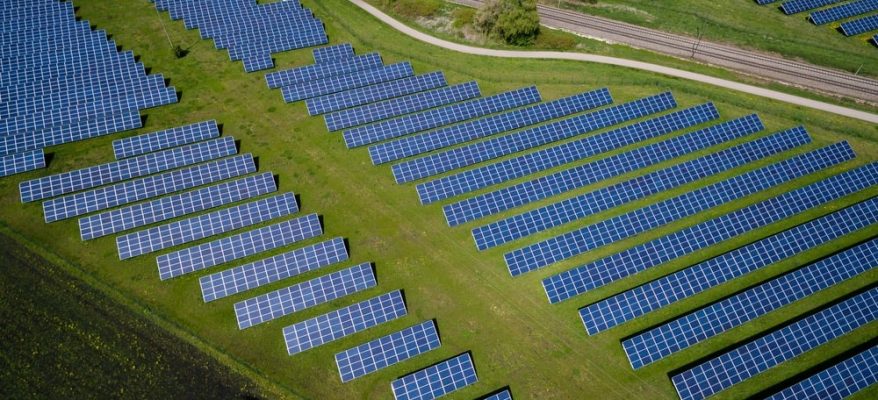 Solar panels installed on a grassy ground